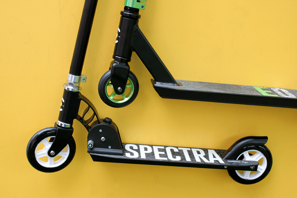 Scooters, one with green details and one with white details